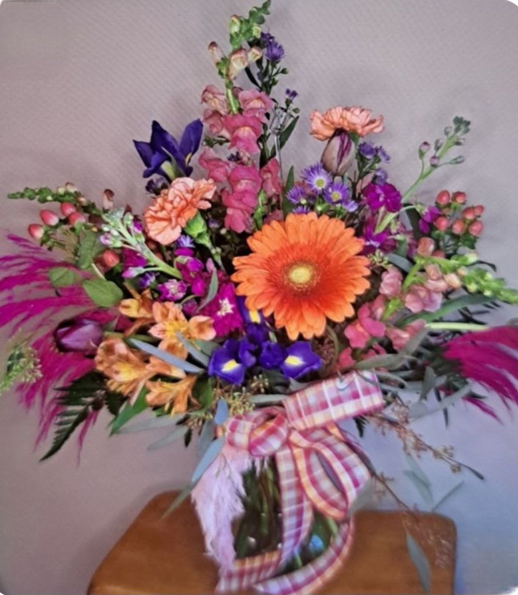 Vibrant Plumes - Bright mixed bouquet of orange gerbera, pink and purple blooms, snapdragons and daisies with plaid ribbon and white feather-cheerful, layered arrangement for birthdays or everyday gifting. Can be customized by size for a larger price. 