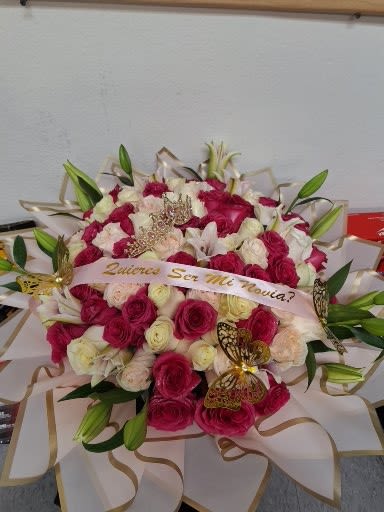 Bouquet of pink and white roses with lilies and ribbon