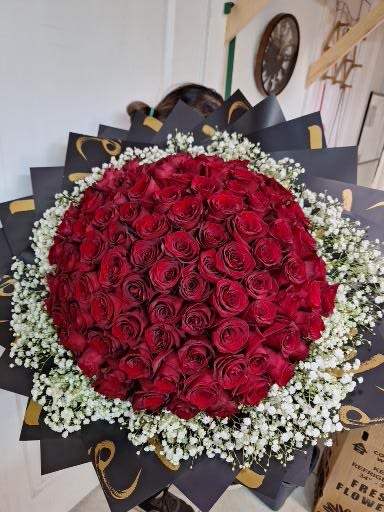 Large bouquet of red roses with white baby's breath