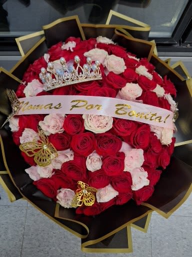 Bouquet of red and pale pink roses with a crown and ribbon