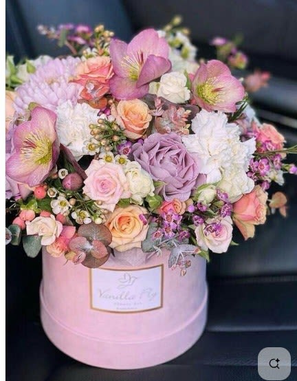 Pink and lavender mixed bouquet in a round pink box