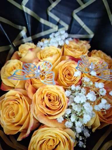 Bouquet of yellow roses with baby's breath and butterfly picks