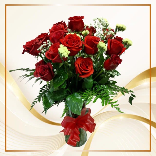 Bouquet of red roses with baby's breath in a glass vase