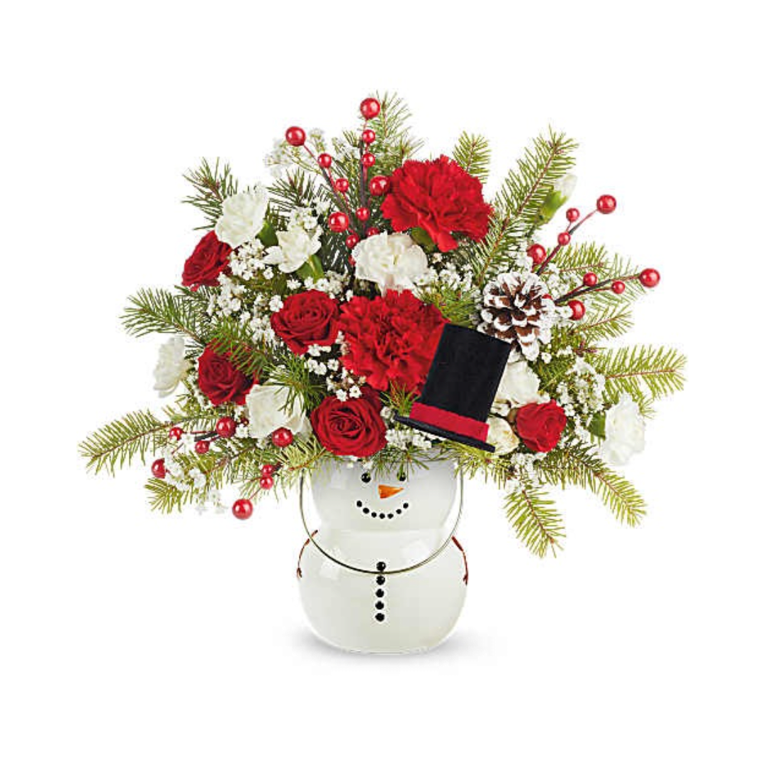 Red and white floral arrangement in a snowman vase with a small top hat