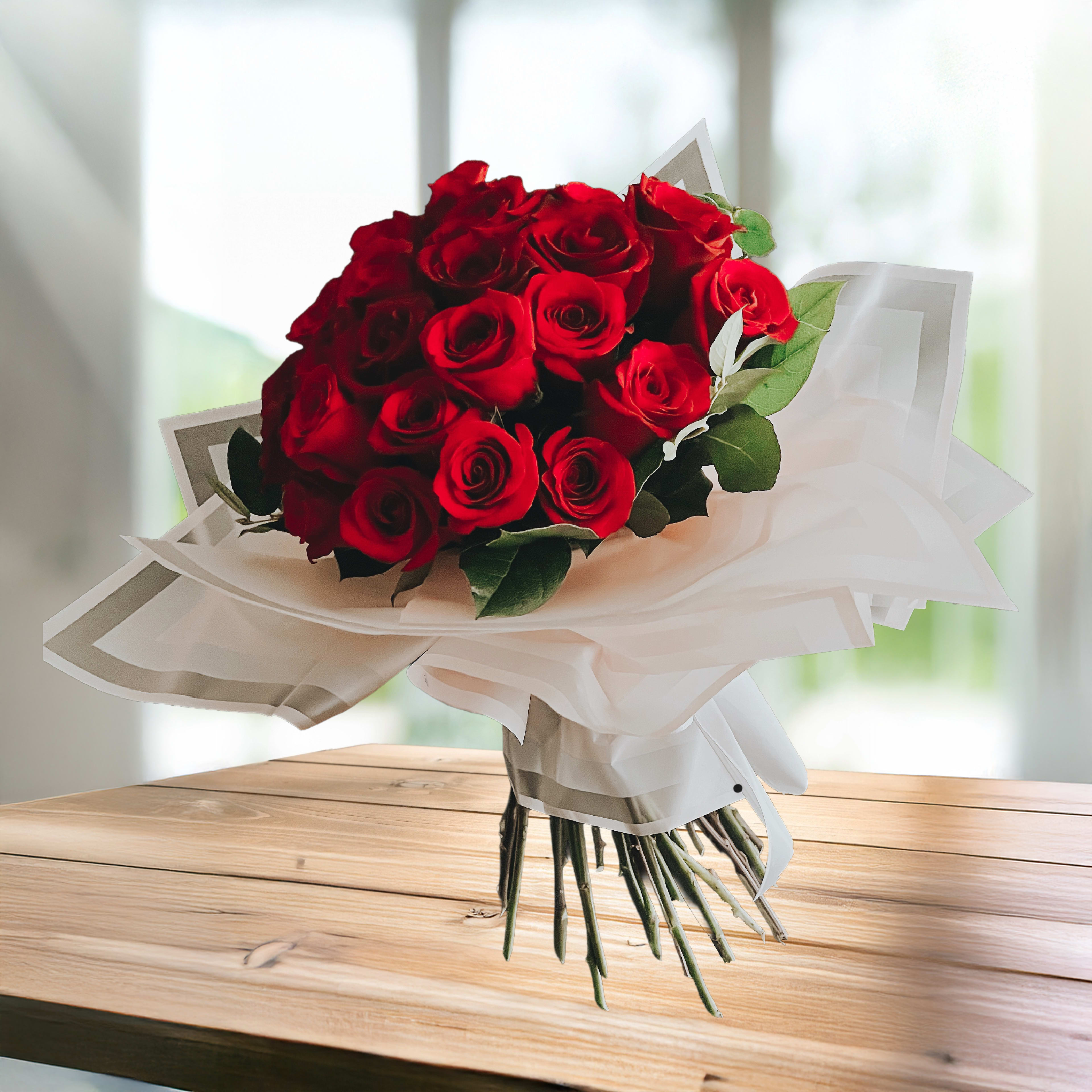 Bouquet of red roses wrapped in white paper
