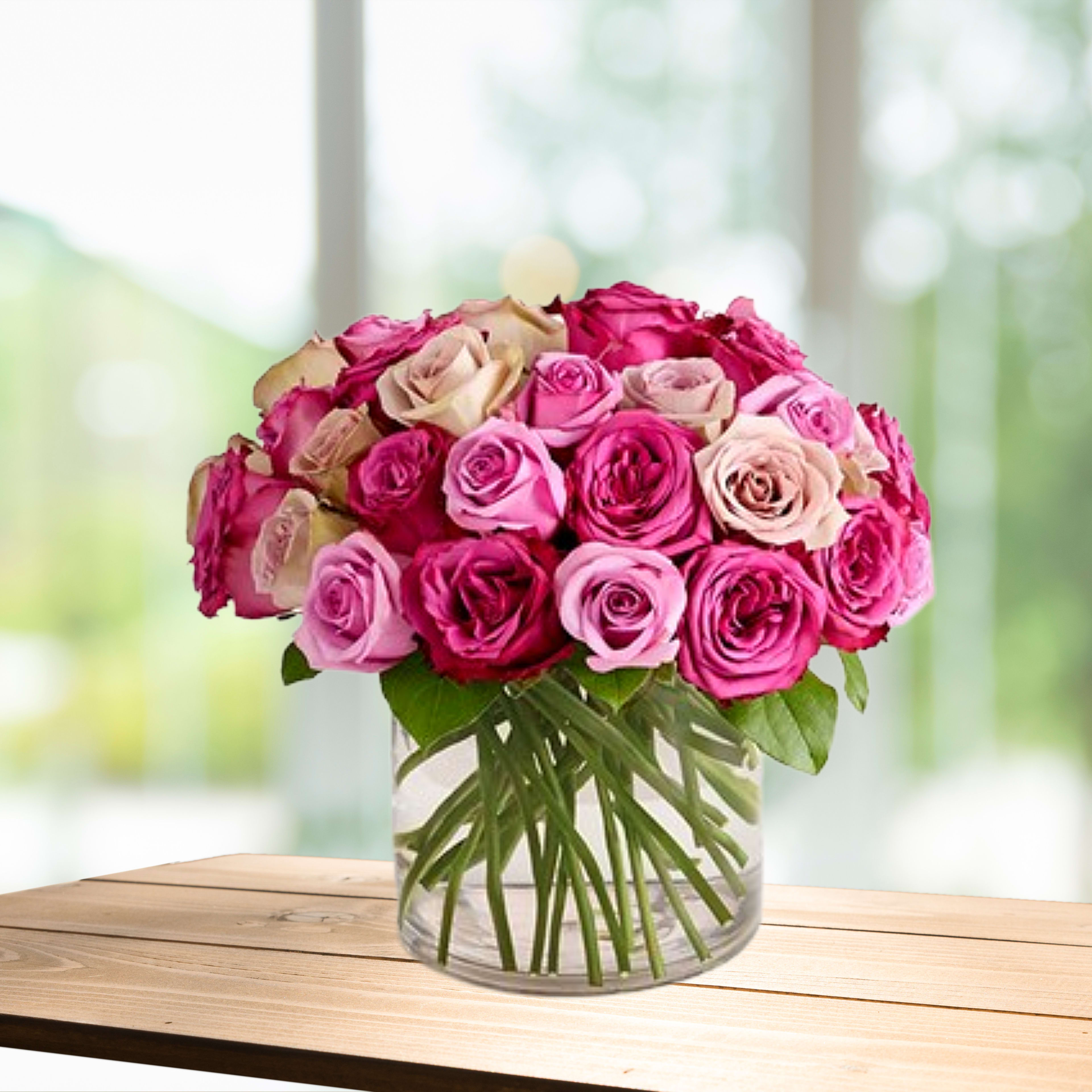 Bouquet of pink and blush roses in a clear glass vase
