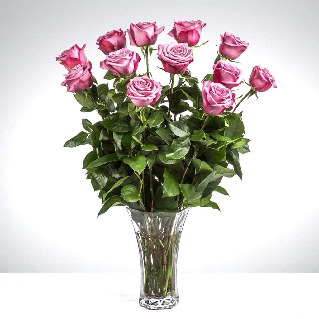 Pink roses arranged in a clear glass vase