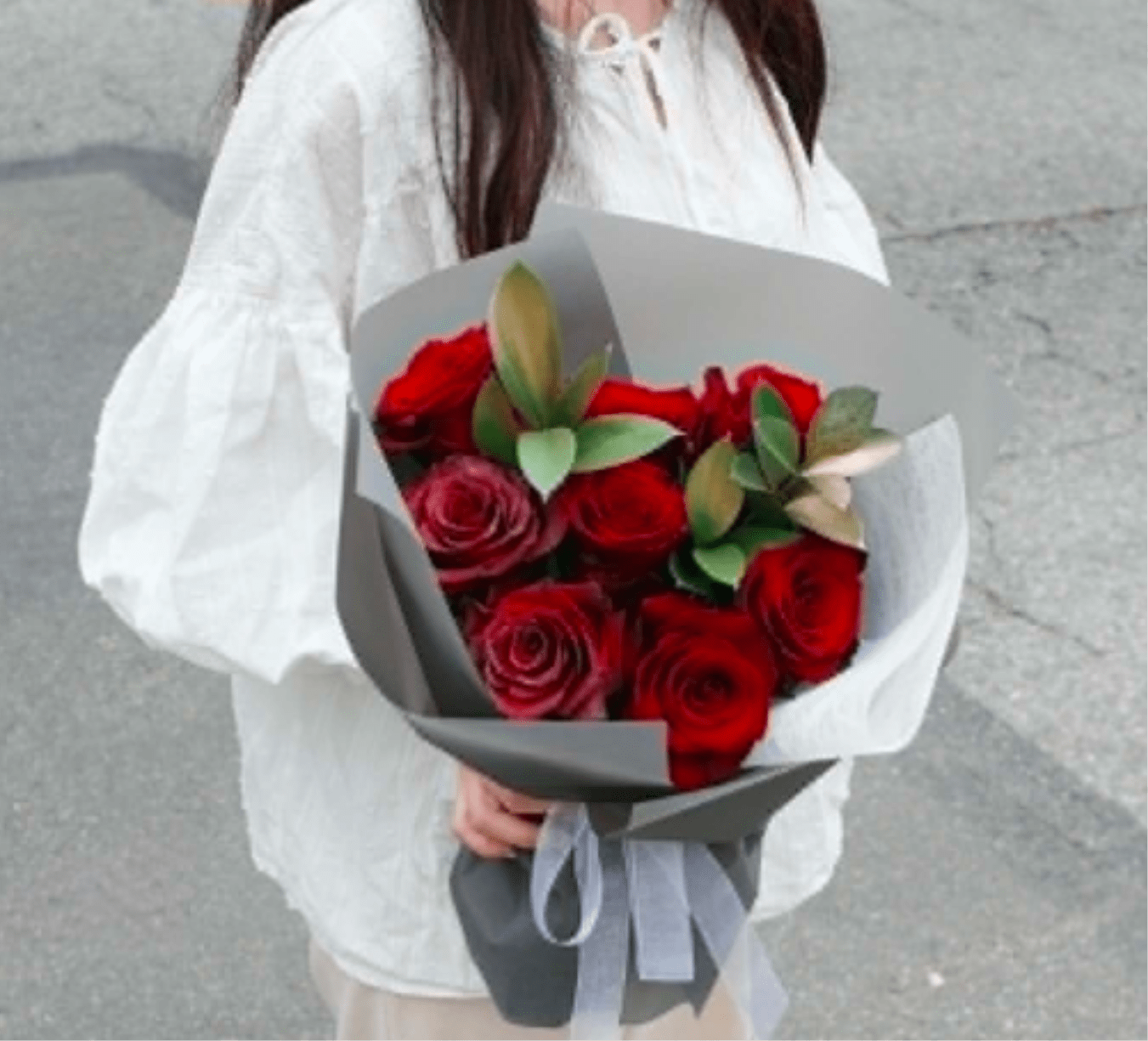 Crimson Grace Roses - Velvety red roses framed by soft greenery, wrapped in sleek gray paper and tied with a sheer ribbon. Crimson Grace embodies passion with romance — a modern, timeless bouquet for romantic gestures or heartfelt admiration