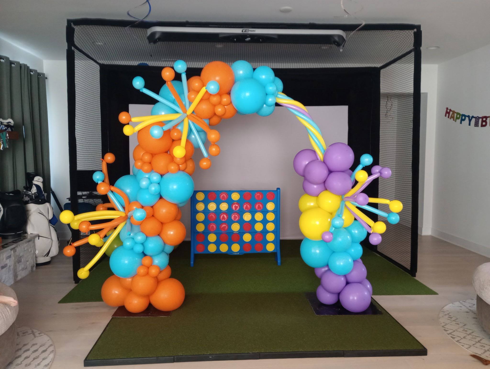 Colorful balloon arch around a Connect Four game board