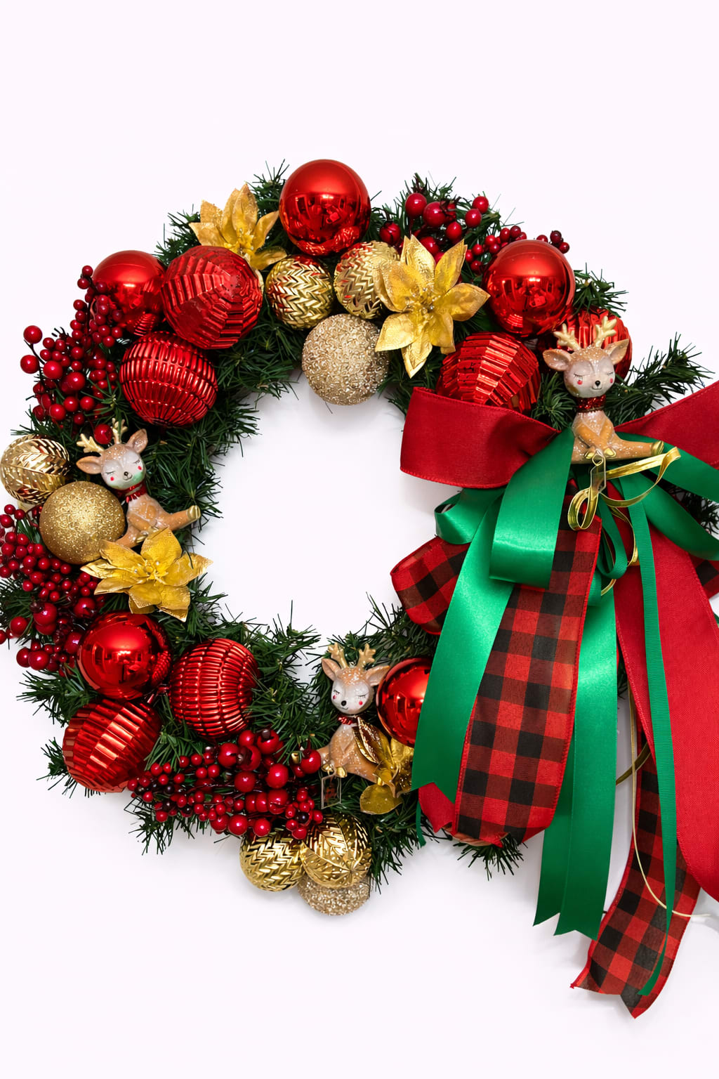 Christmas wreath with red and gold ornaments, reindeer figurines, and a large red and green bow