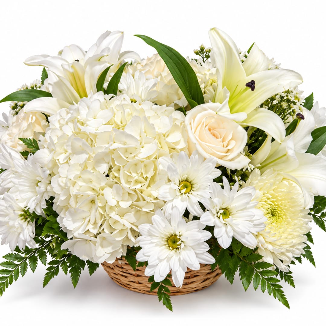 White lilies, hydrangeas, daisies, and a cream rose in a wicker basket