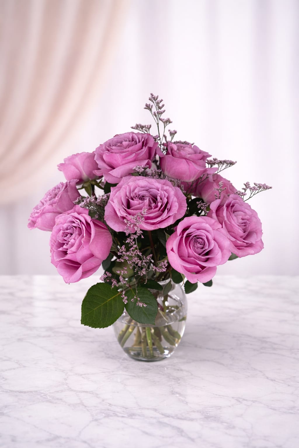 Pink roses arranged in a clear glass vase