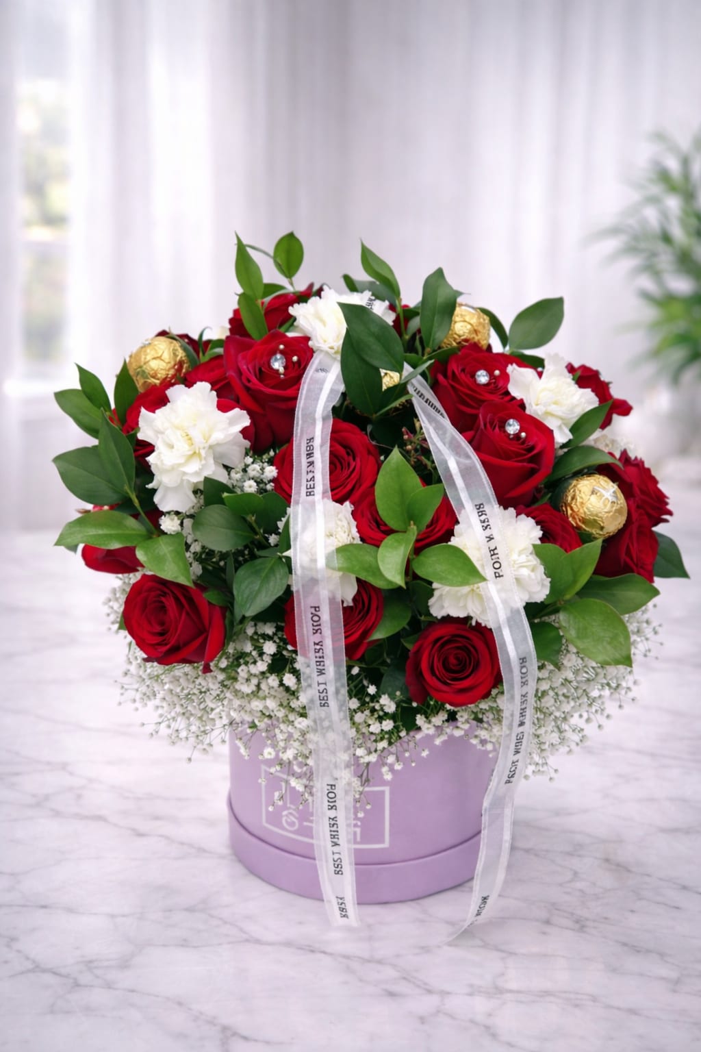 Bouquet of red roses and white carnations in a lavender box
