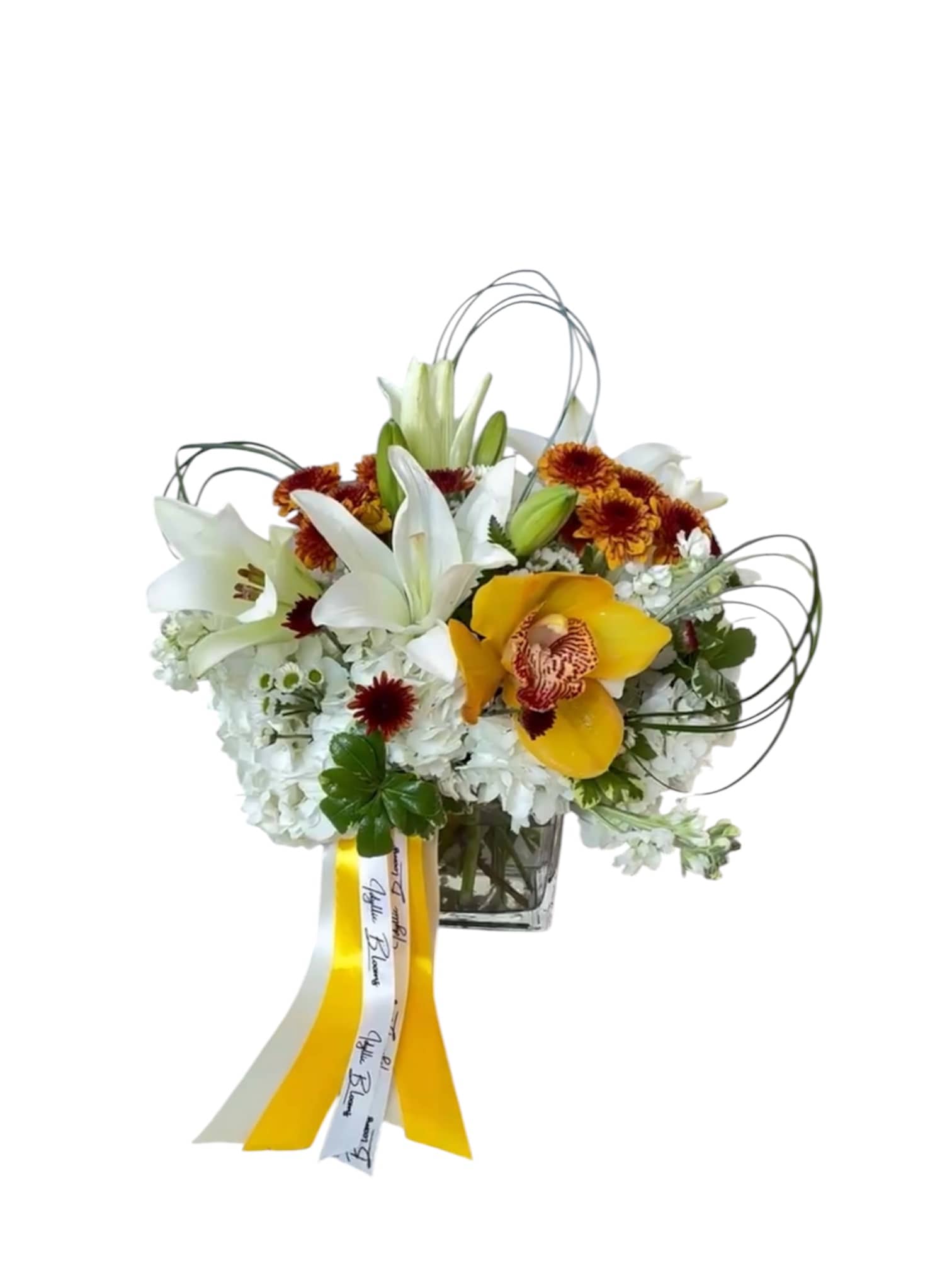 White lilies and yellow orchids in a glass vase with ribbon streamers