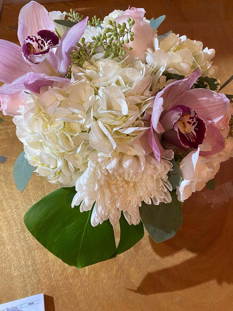 Bouquet of white hydrangeas, pink orchids, and white chrysanthemums