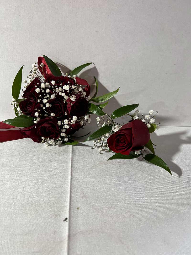 Red rose bouquet with baby's breath and a matching boutonniere