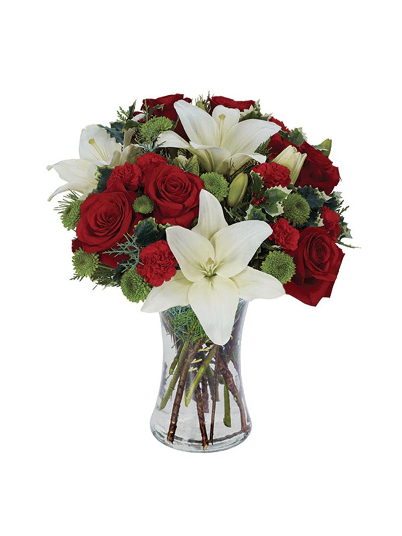 Red roses and white lilies arranged in a clear glass vase