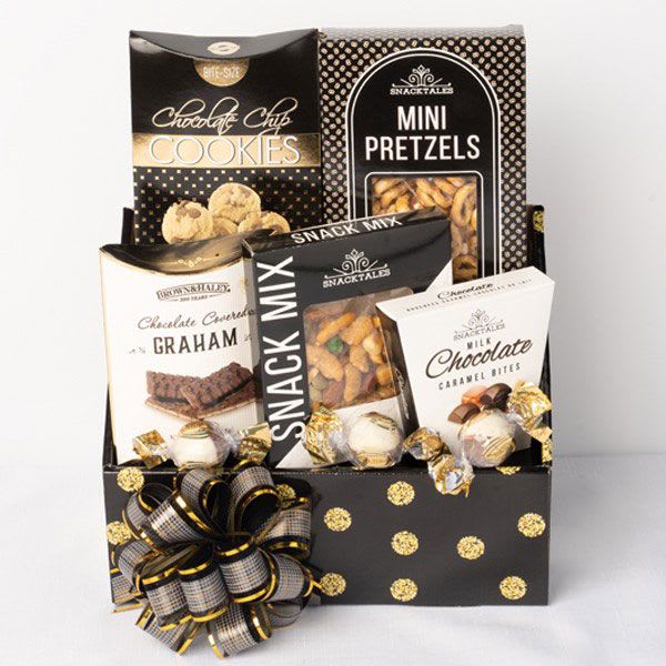 Gift basket with assorted snack boxes and chocolates in a black polka-dot container