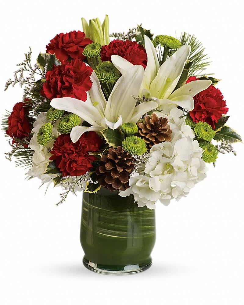 Red carnations and white lilies in a green glass vase with pinecones