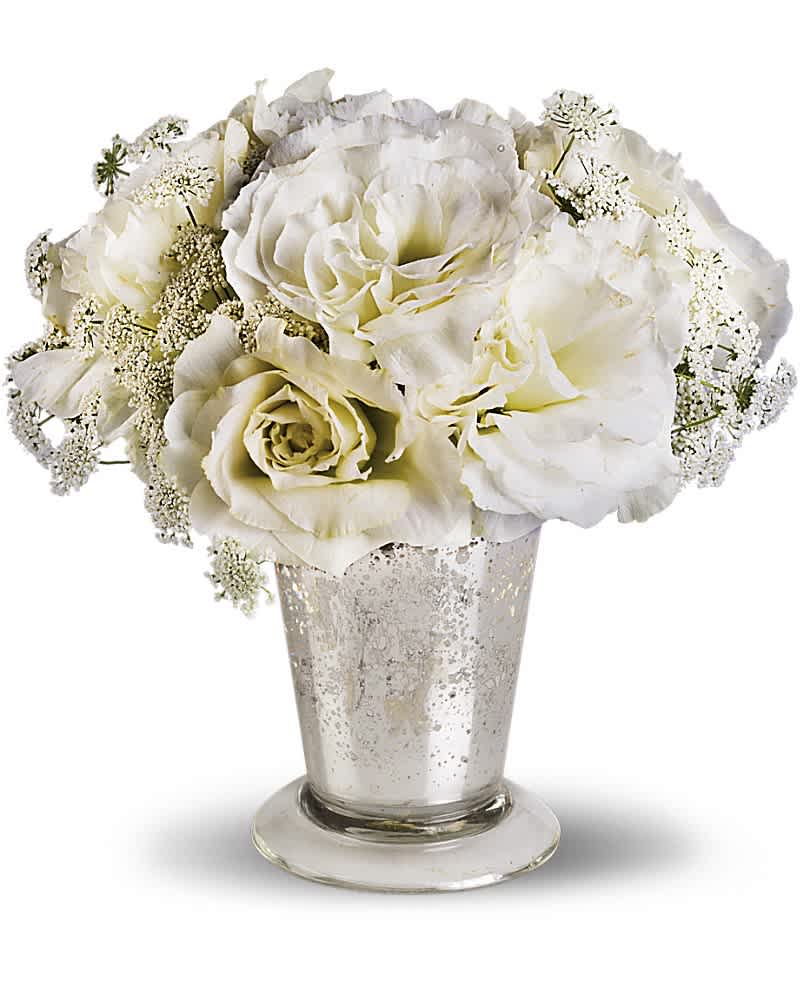 White roses in a silver vase with delicate filler flowers