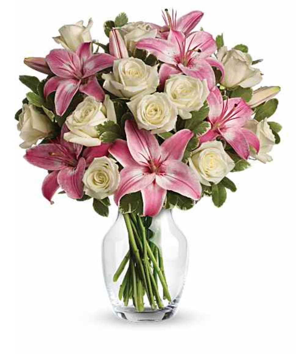 Always a Lady Bouquet  - She'll always be your #1 lady. Remind her just how special she is - send a sensational gift she'll never forget. This beautiful bouquet of fragrant pink lilies and lush white roses is sure to make an impression! Seventeen white roses are mixed with pink asiatic lilies and variegated pittosporum in a classic clear glass rose vase. Orientation: All-Around  SUBSTITUTION POLICY – Always deliver the freshest flowers! Please note the bouquet pictured reflects our original design.  If the exact flowers or container in this arrangement are not available, our local florists will create a beautiful bouquet with the freshest available flowers.