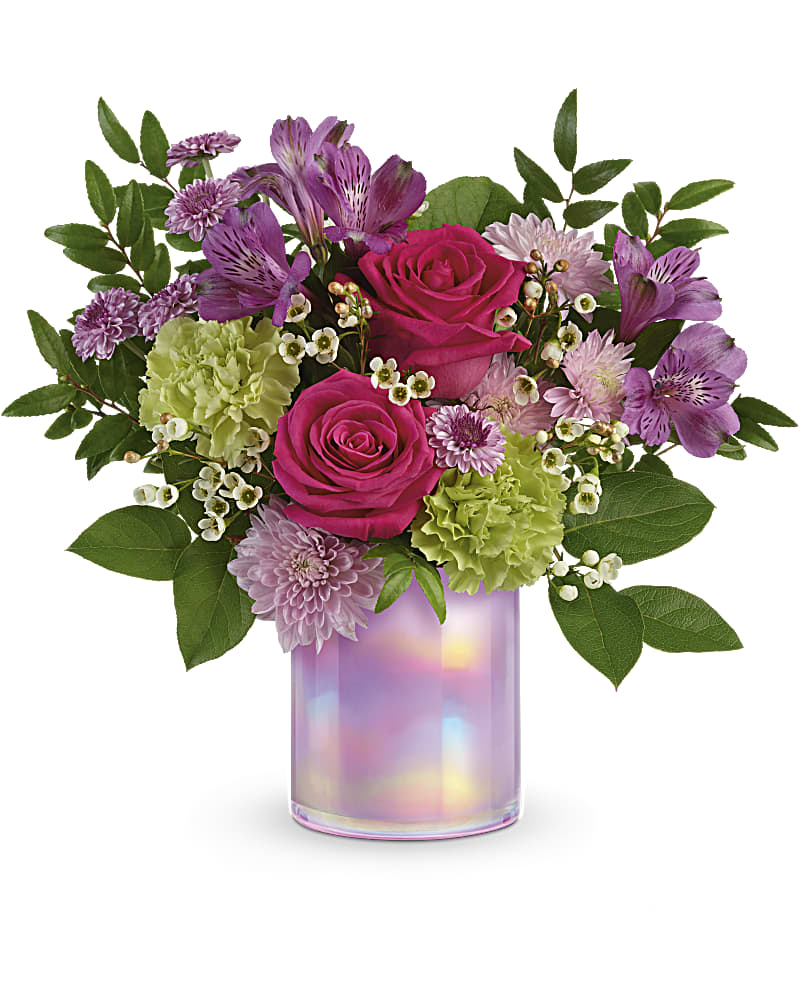 Pink roses and purple flowers arranged in an iridescent glass vase
