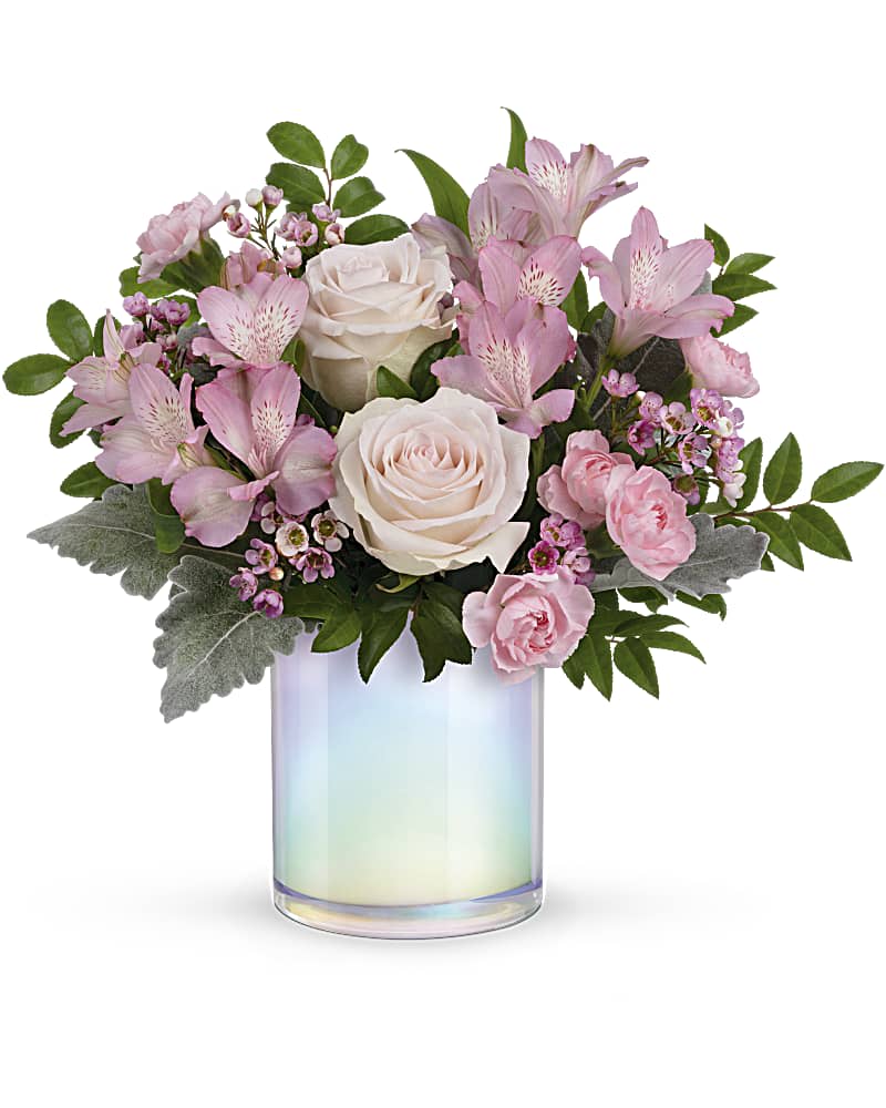 Pink and white flower arrangement in an iridescent glass vase