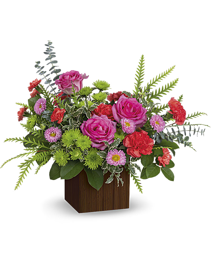 Pink roses and mixed flowers arranged in a wooden cube vase