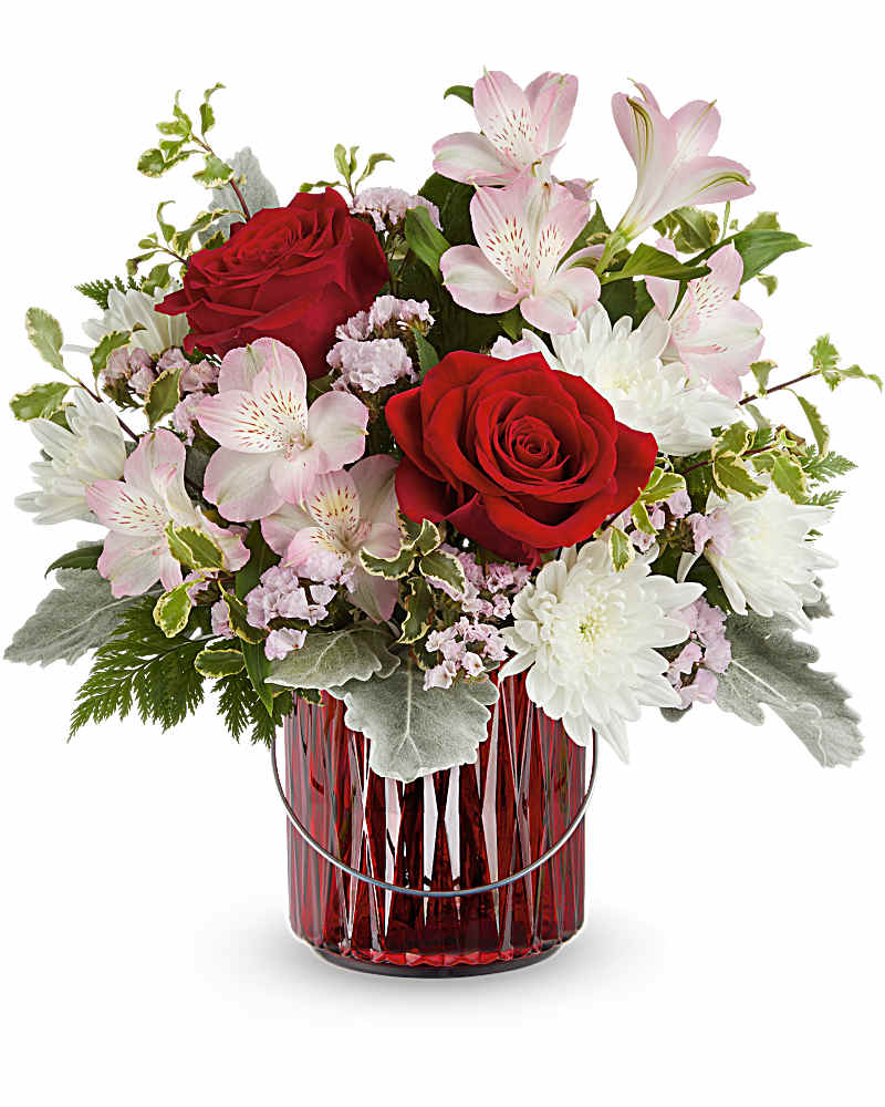 Red roses and pink lilies in a red glass vase