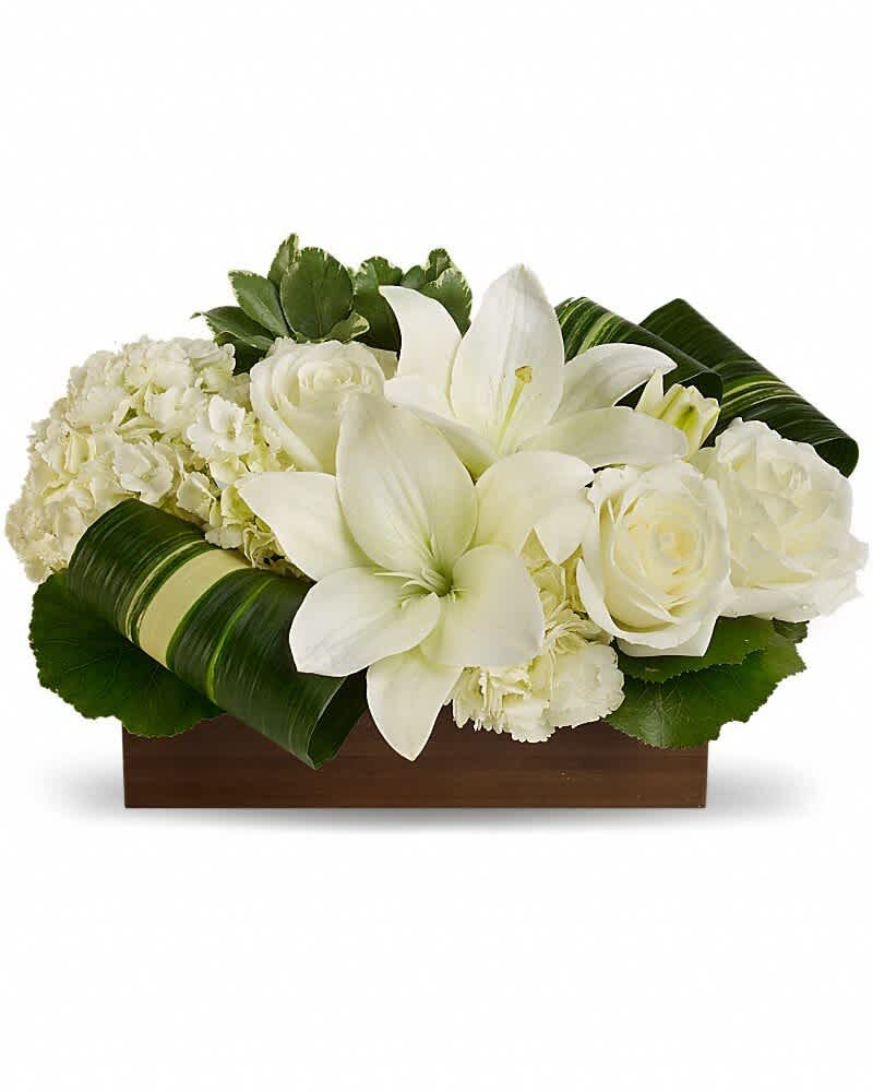 White lilies and roses arranged in a wooden box