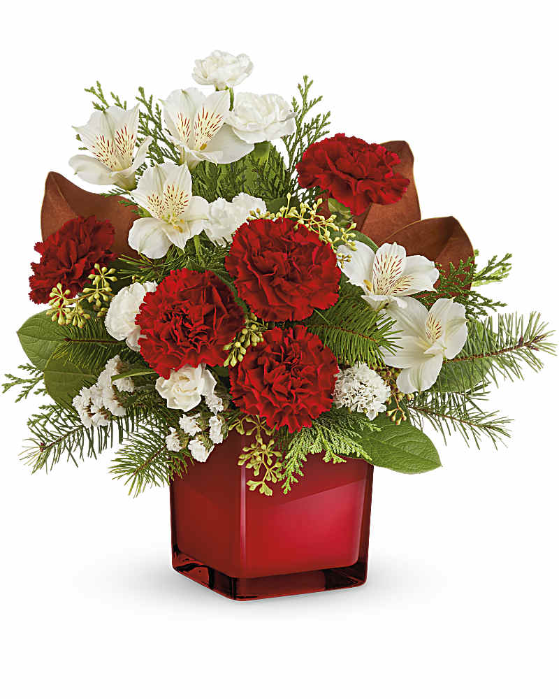 Red and white floral arrangement in a red glass vase