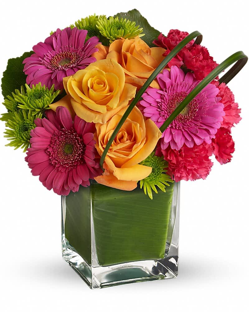 Colorful bouquet of roses, gerbera daisies, and carnations in a glass vase