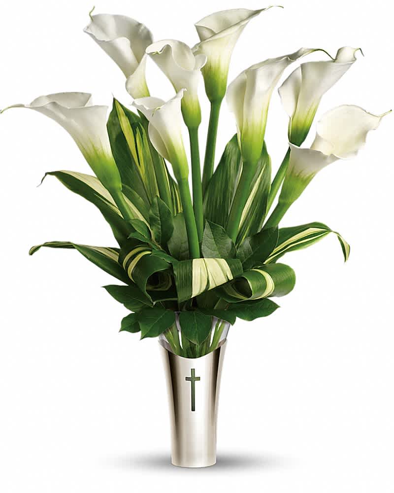 White calla lilies arranged in a tall vase with a cross emblem