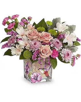 Hummingbird Surprise Bouquet - Sweet as a hummingbird flitting through a garden, this pretty pink rose bouquet looks lovely in a vintage-inspired cube vase. Pink spray roses, pink alstroemeria, miniature lavender carnations, lavender cushion spray chrysanthemums, green button spray chrysanthemums and pink sinuata statice are arranged with dusty miller and lemon leaf. Delivered in a Sweet Hummingbird Cube