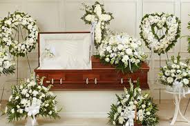    Elegant funeral floral arrangement (box or standing style) - A graceful sympathy arrangement made with fresh white roses, symbolizing love, appreciation, and remembrance. Designed with soft greenery and delicate accents, this elegant piece offers a heartfelt way to express condolences and honor a loved one.