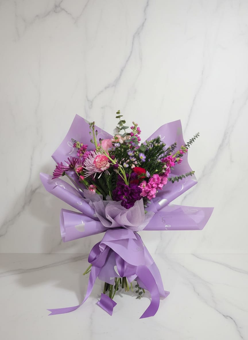 Pink and Purple Spring Bouquet - Delicate, romantic, and beautifully arranged, this stunning hand tied bouquet, the combination between, chrysanthemums, carnations, spray roses, asters, snapdragons, and Eucalyptus.  Delicado, romántico y bellamente arreglado, este impresionante ramo atado a mano, la combinación de crisantemos, claveles, rosas en ramillete, ásteres, rododendro y eucalipto. 