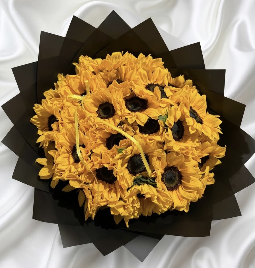 Sunflower Bouquet – Premium Fresh Sunflowers Arrangement - Brighten someone’s day with this stunning sunflower bouquet, beautifully arranged to celebrate happiness, warmth, and positive energy. Each bouquet features fresh, vibrant sunflowers carefully selected and wrapped in elegant black paper, creating a striking contrast that makes the golden-yellow blooms stand out. Its bold and cheerful design makes it perfect for birthdays, anniversaries, congratulations, romantic surprises, the Yellow Flowers celebration, or simply reminding someone how special they are. Available in 20, 30, or 50 sunflowers, this bouquet can be customized according to the size of the gesture you wish to make. Every arrangement is handcrafted with care, so the placement and appearance of the flowers may vary slightly based on seasonal availability. A complimentary dedication card is included, allowing you to add a personal message for the recipient.
