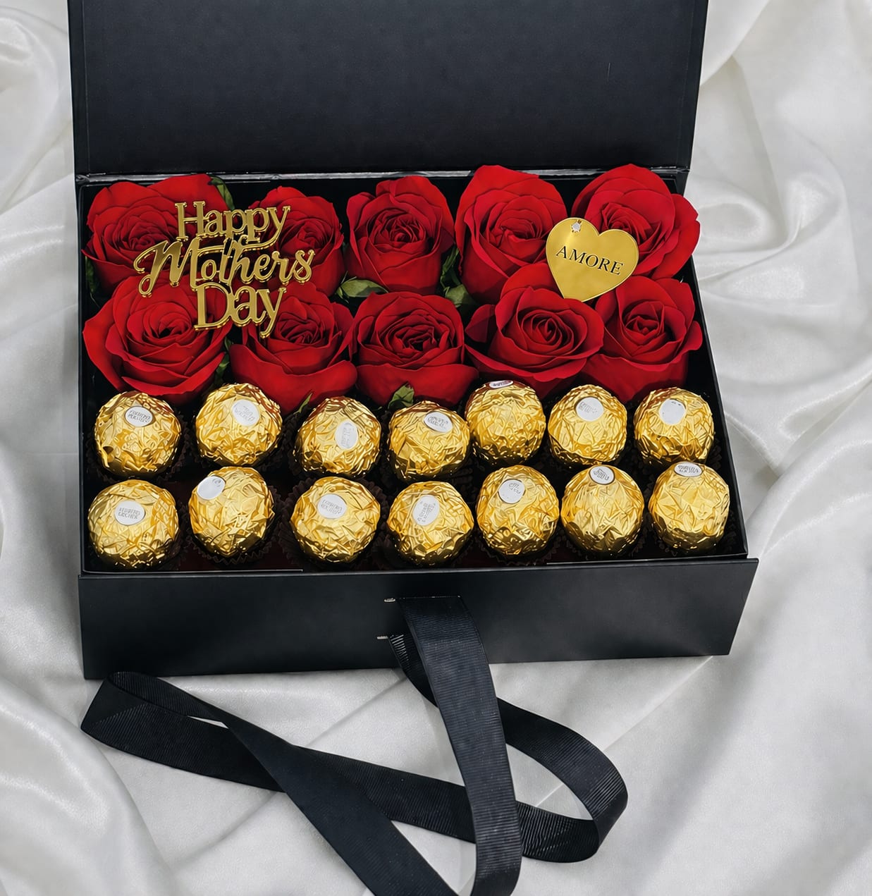 Luxury Rose &amp; Chocolate Gift Box - Indulge in the perfect balance of elegance and sweetness with our Luxury Rose &amp; Chocolate Gift Box. This beautifully designed arrangement features fresh premium roses carefully arranged inside a sleek gift box, paired with delicious gourmet chocolates for an unforgettable surprise.  Each piece is handcrafted with attention to detail, creating a refined and romantic presentation ideal for birthdays, anniversaries, Valentine’s Day, or any special moment that deserves something extraordinary.  Available in white or black box options. Rose colors may vary depending on availability while maintaining the same elegant style and design.  A timeless gift designed to impress. 