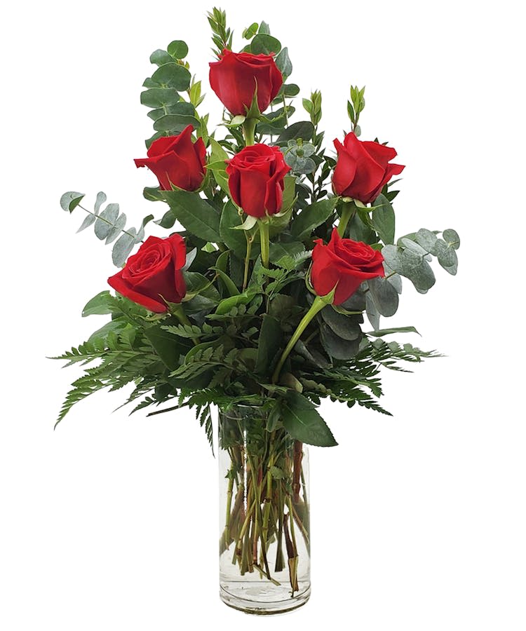 Romantic Bouquet - Hand-arranged half dozen red roses accented with fresh greenery, celebrating love in its purest and most timeless form.
