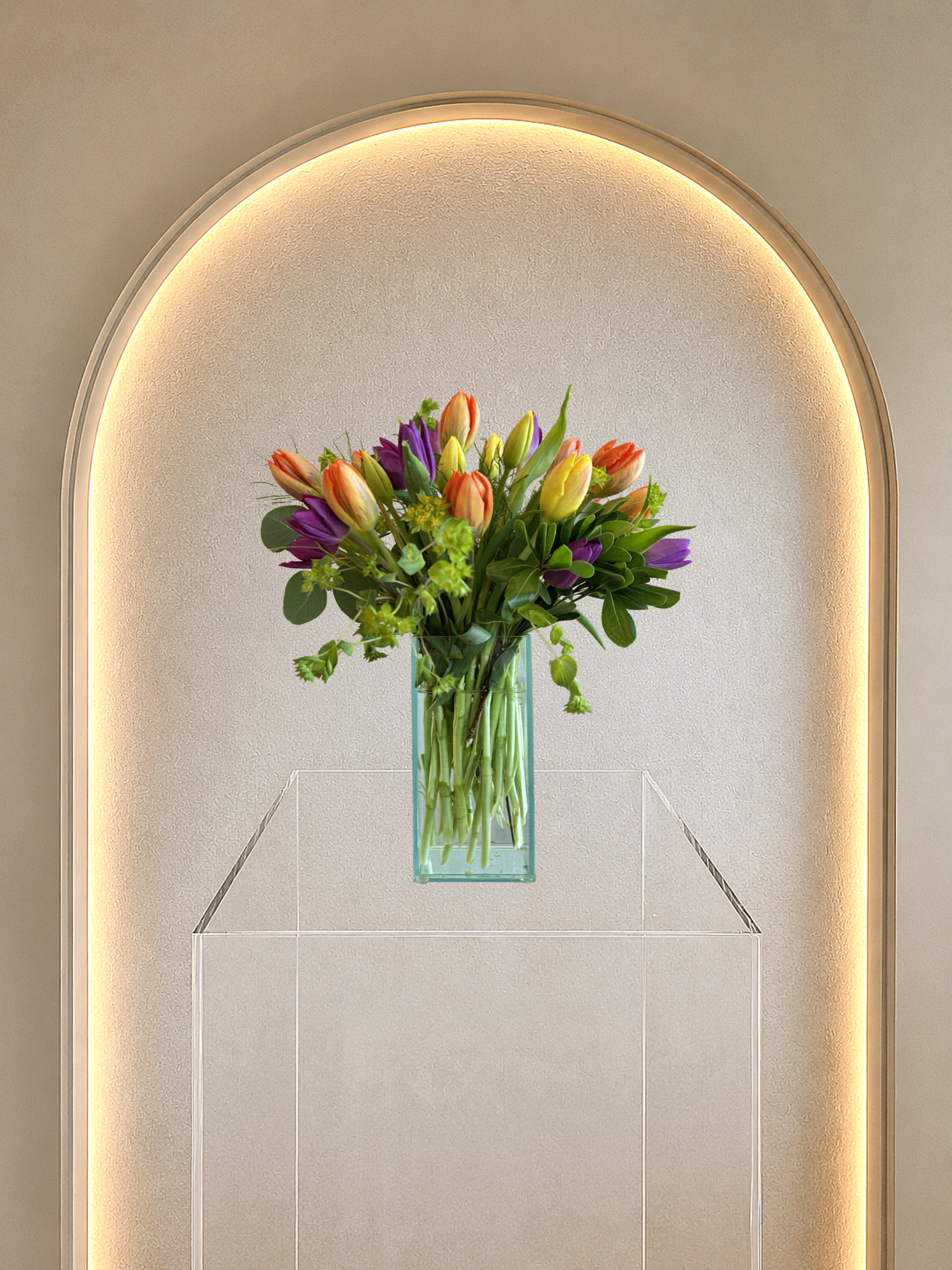 Tulipa - Mixed tulips with green accents in a clear rectangular vase-fresh, cheerful spring bouquet perfect for brightening birthdays or everyday displays.