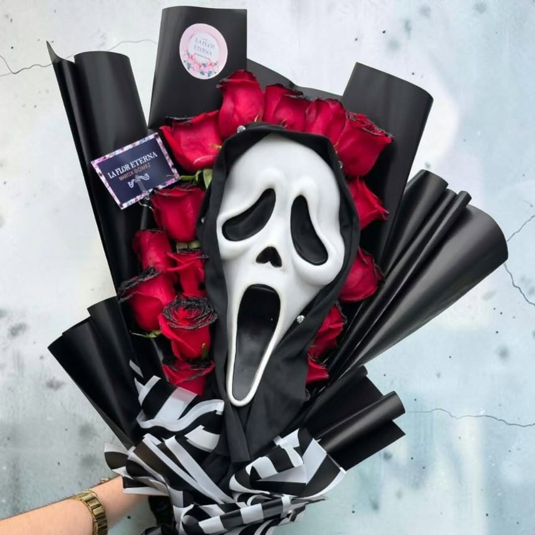 Bouquet of red roses with a white Ghostface mask and black wrapping.