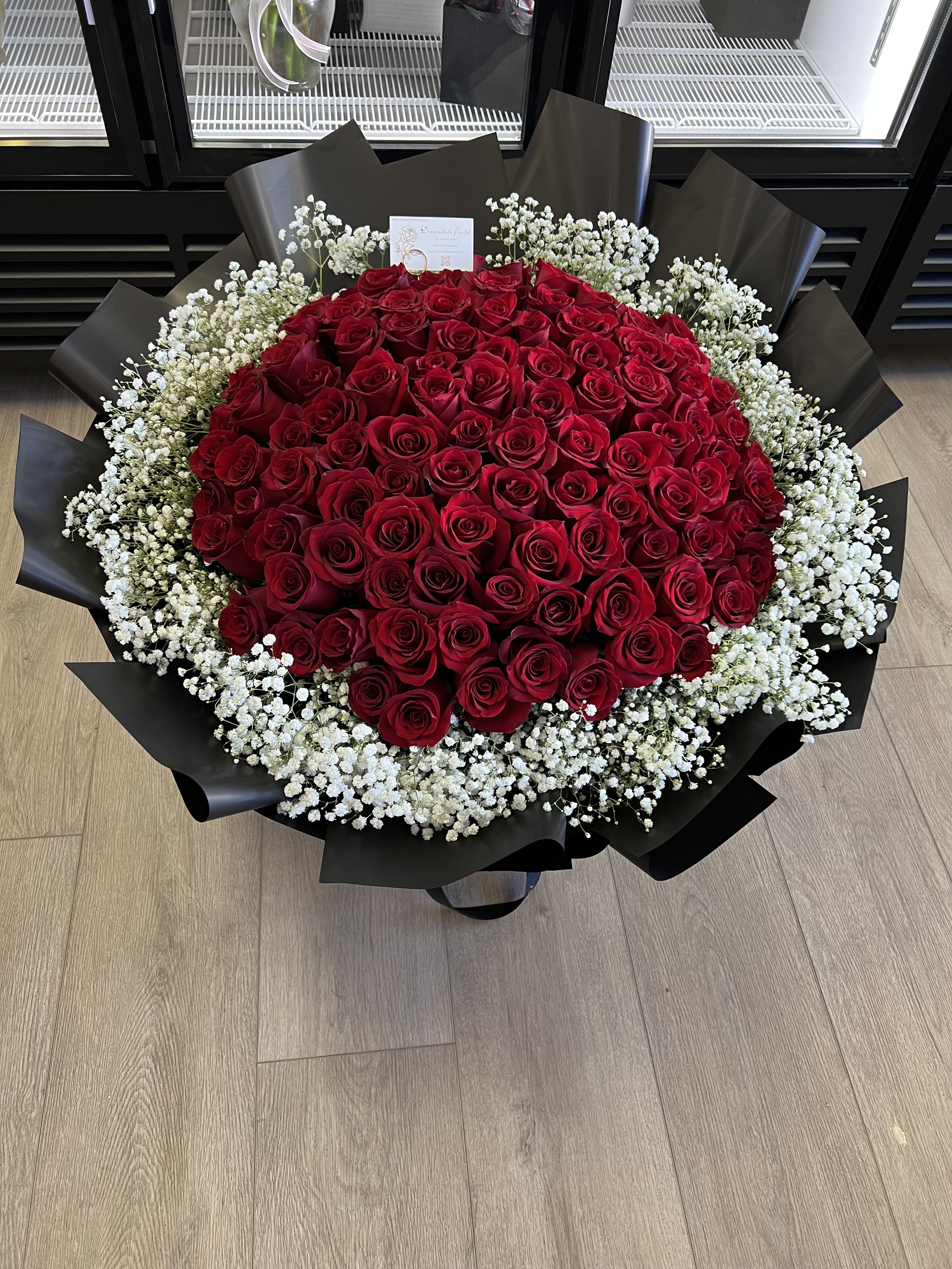 99 stems roses bouquet  - A breathtaking statement of love and devotion ️  This luxurious bouquet features 99 stunning roses beautifully surrounded by clouds of delicate baby’s breath, creating a dreamy and romantic look that feels both grand and timeless. Each rose represents deep love, admiration, and forever commitment, while the soft white blooms add elegance, lightness, and charm.  Wrapped in premium layers and designed to impress, this arrangement is perfect for anniversaries, proposals, birthdays, or any moment when words are simply not enough.  Bold, romantic, and unforgettable — a true symbol of endless love 