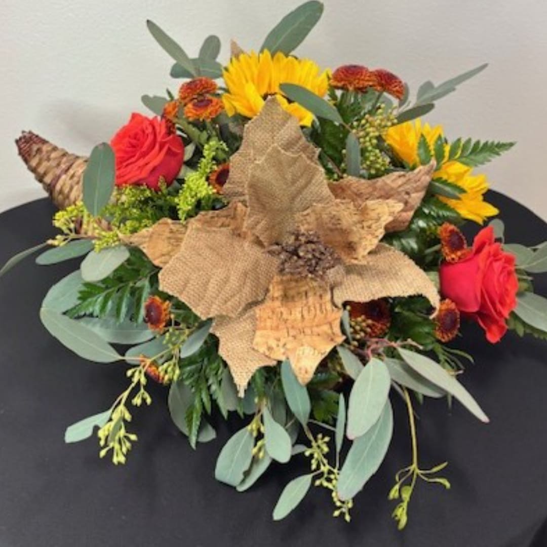 Autumn bouquet with red roses, yellow sunflowers, and burlap leaf accents