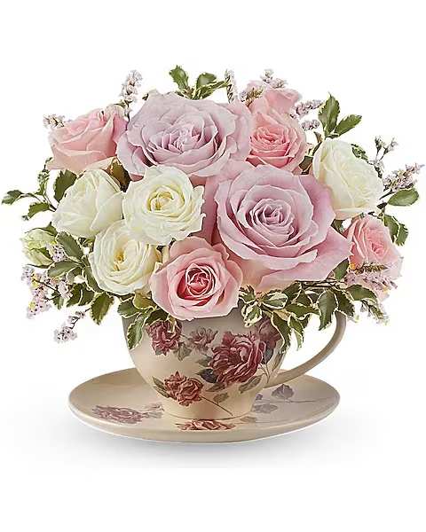 Teleflora's Blossoming Petals Bouquet - Brighten someone's day with our Blossoming Petals bouquet, beautifully arranged in a charming ceramic teacup. This delightful arrangement features a lovely mix of vibrant blooms in soft pastel shades, bringing a touch of cheer to any occasion. Celebrate with a delightful arrangement of pink roses, pink spray roses, and white spray roses, complemented by soft pink limonium and pitta negra. Teleflora's Blossoming Petals Bouquet is beautifully presented in a teacup and saucer with a Victorian flower pattern.  Orientation : All-Around  All prices in USD ($)  Standard TEV73-9A  Deluxe TEV73-9B  Premium TEV73-9C