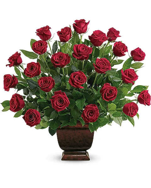 Teleflora's Rose Tribute - As true as the love symbolized by a red, red rose are the heartfelt memories and deep feelings embraced with this classic and elegant expression of tribute. Four dozen red roses, accented by salal, are presented in an exclusive Noble Heritage Urn.