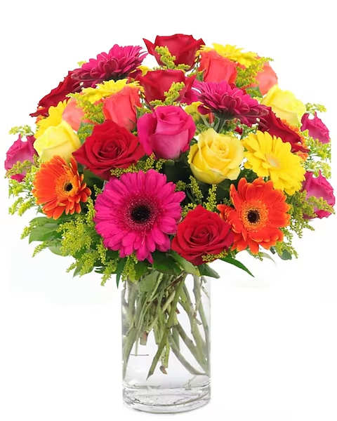 Colorful bouquet of roses and gerbera daisies in a clear glass vase