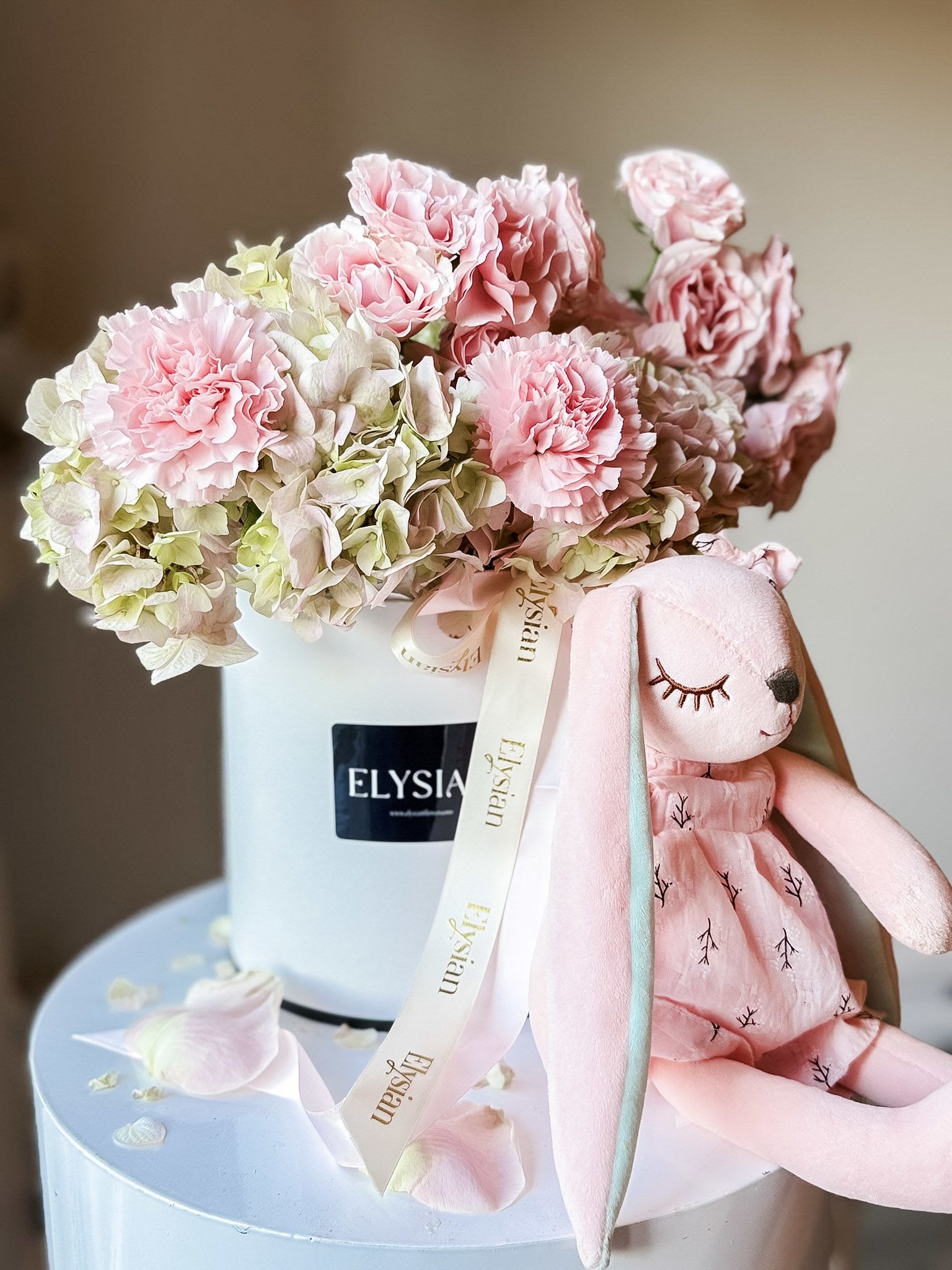 Flower box in pink - Celebrate the arrival of a new bundle of joy with our adorable flower box! Featuring lovely hydrangeas, cheerful carnations, and delicate spray roses, this arrangement is perfect for baby showers or welcoming a newborn. Bright, fresh, and charming, it’s a simple way to show your love and happiness for the little one’s new beginning. Make their day extra special with this sweet floral gift!  Disclaimer  Flower varieties and exact shades may vary based on seasonal availability. Substitutions may be made while maintaining the overall color palette, style, and value of the arrangement to ensure the freshest blooms and the highest design quality.
