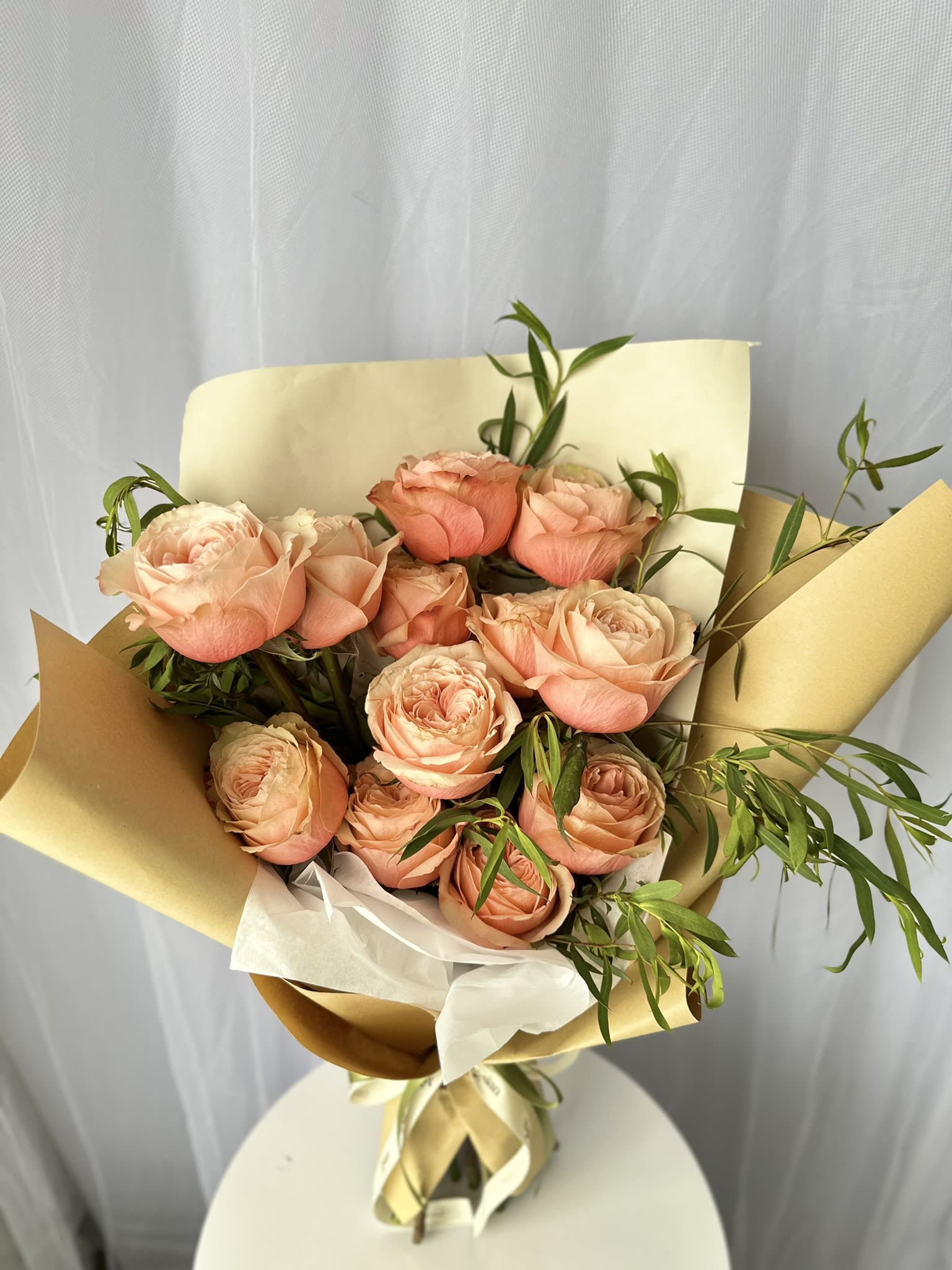 Kahala Rose - Each rose is carefully selected for its lush, full bloom and vibrant color, creating a stunning display of natural beauty.  The addition of eucalyptus foliage adds a touch of sophistication and a refreshing aroma, perfectly balancing the rich, romantic roses.