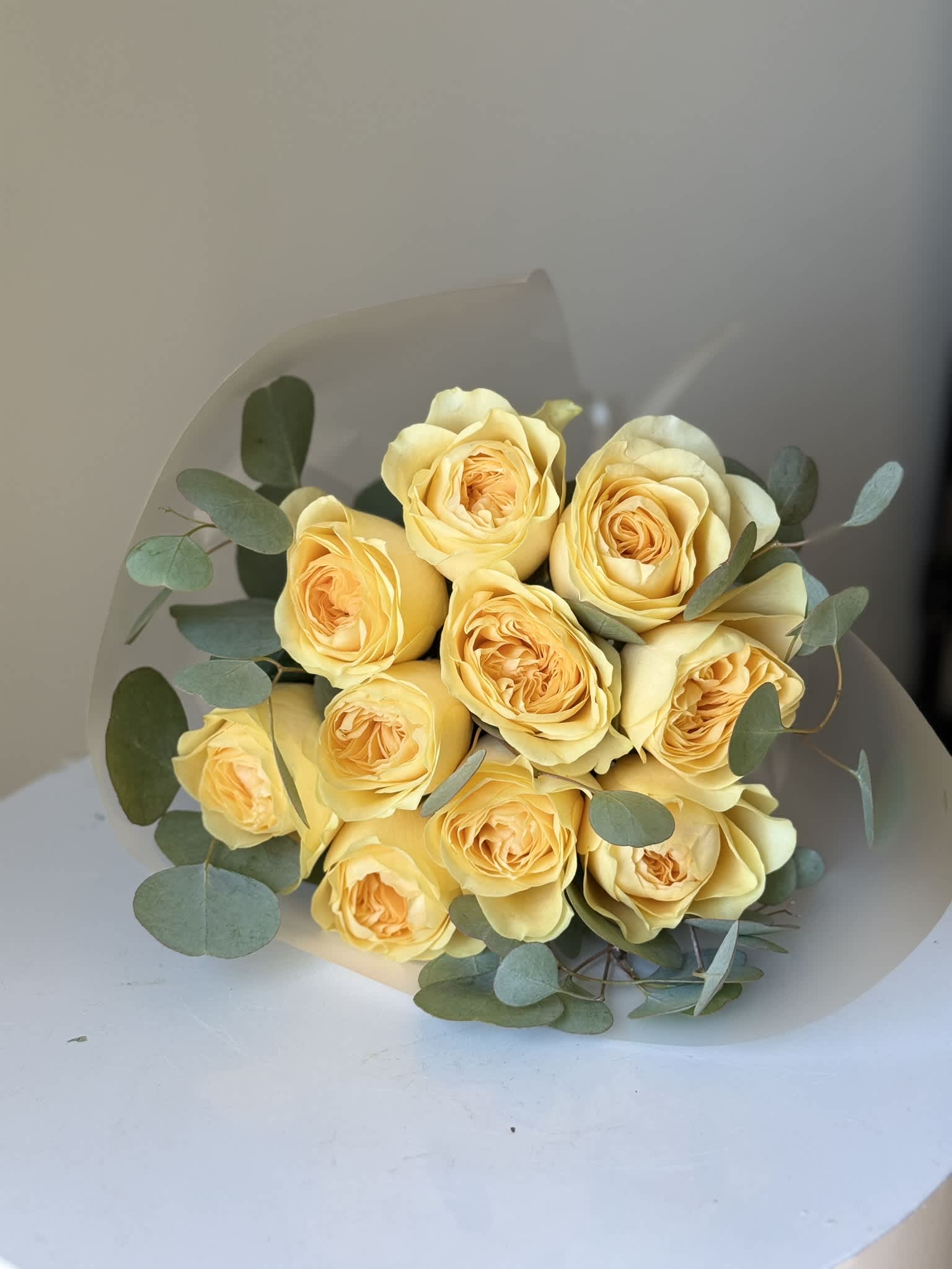 Bouquet of pale yellow roses with eucalyptus foliage