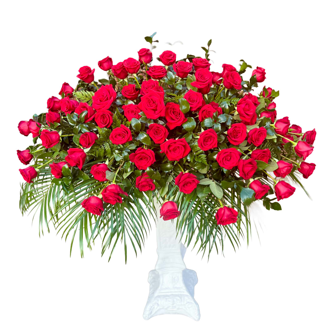 100 Rose Salute - 100 red roses artfully arranged on beds of palm creating a stunning classic tribute. 